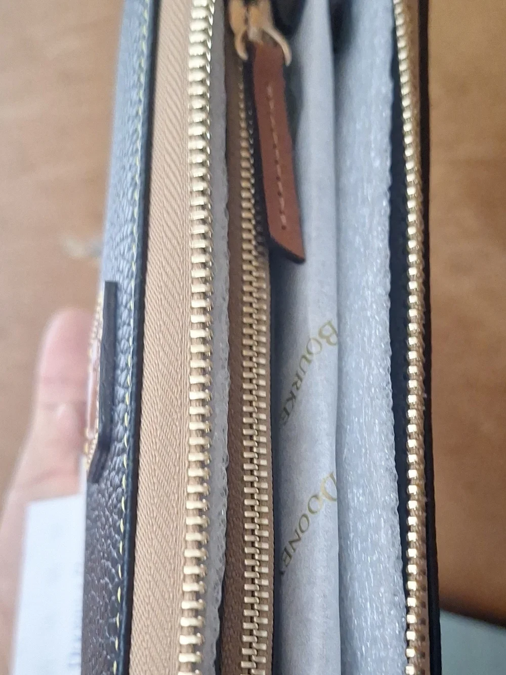 Dooney & Bourke Black Pebbled Zip Wallet with Tan Trim